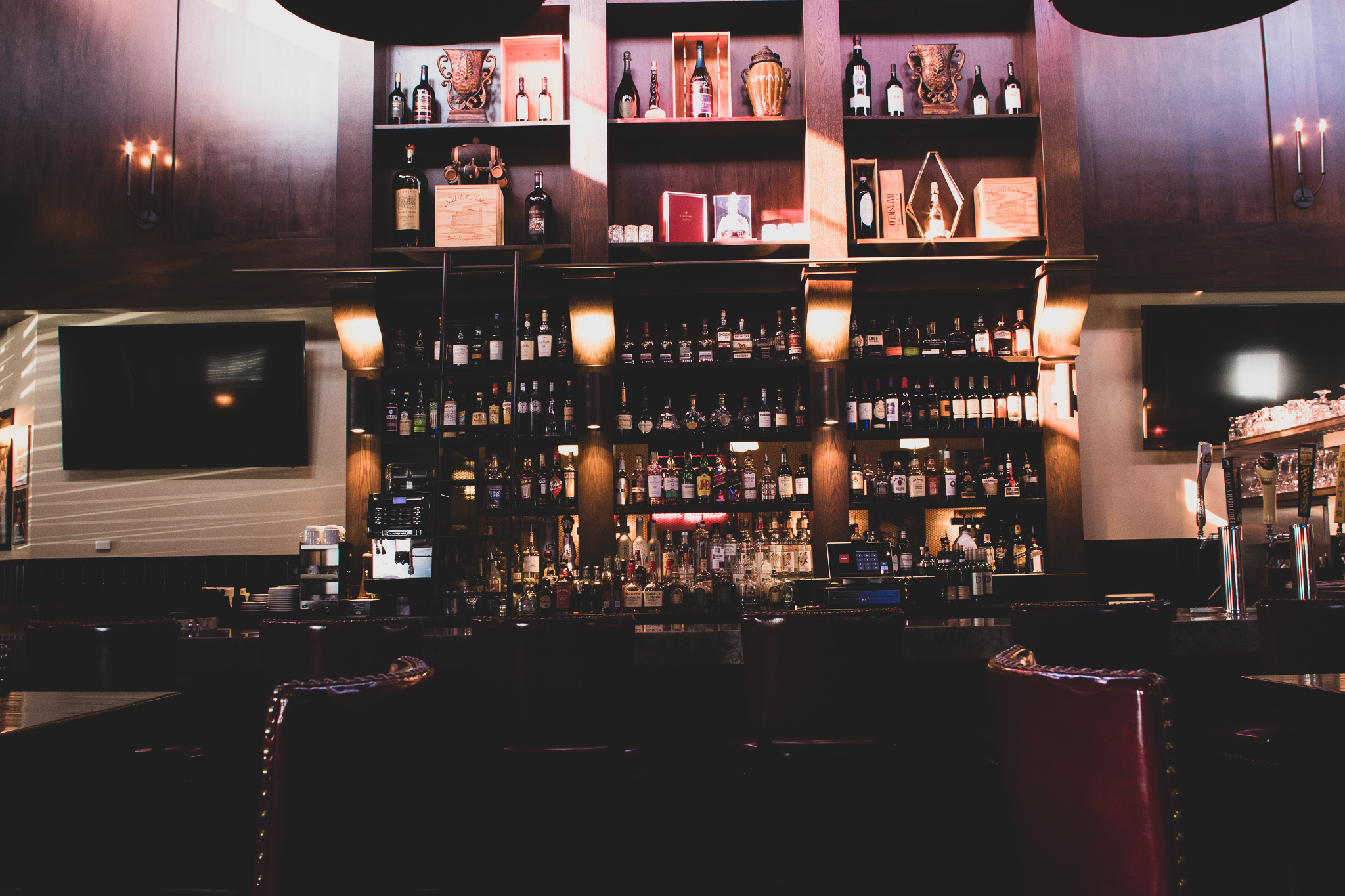 The bar at Da Francesco's, lined with bottles and leather seating