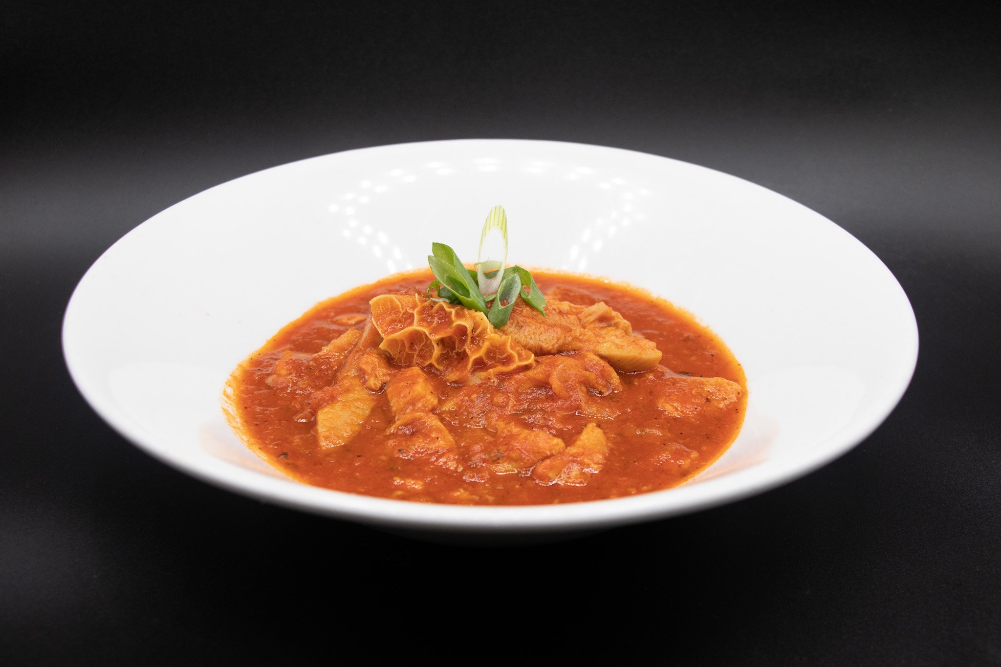 Tripe in tomato broth with scallion