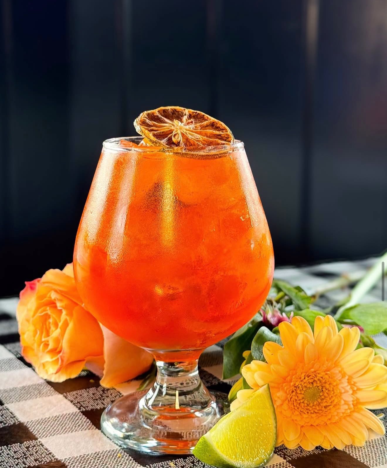 A signature cocktail garnished with dried citrus at the bar