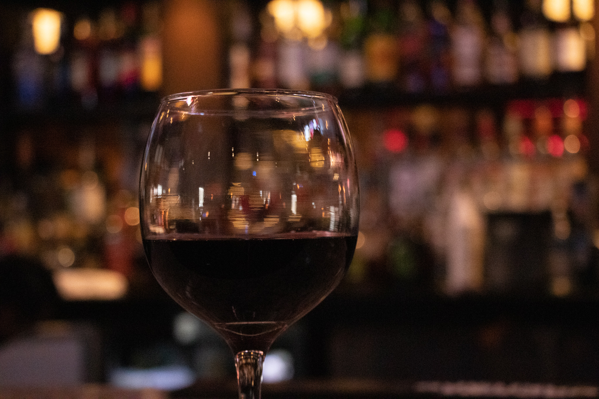 A glass of red wine at the bar
