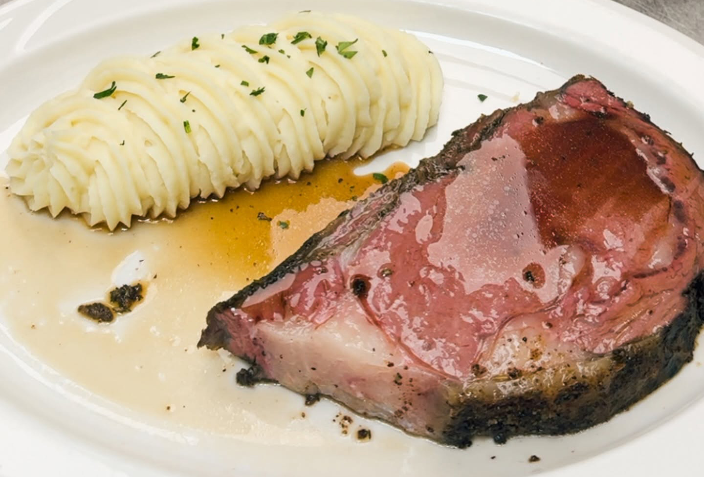 Slow-roasted prime rib with garlic mashed potatoes and au jus