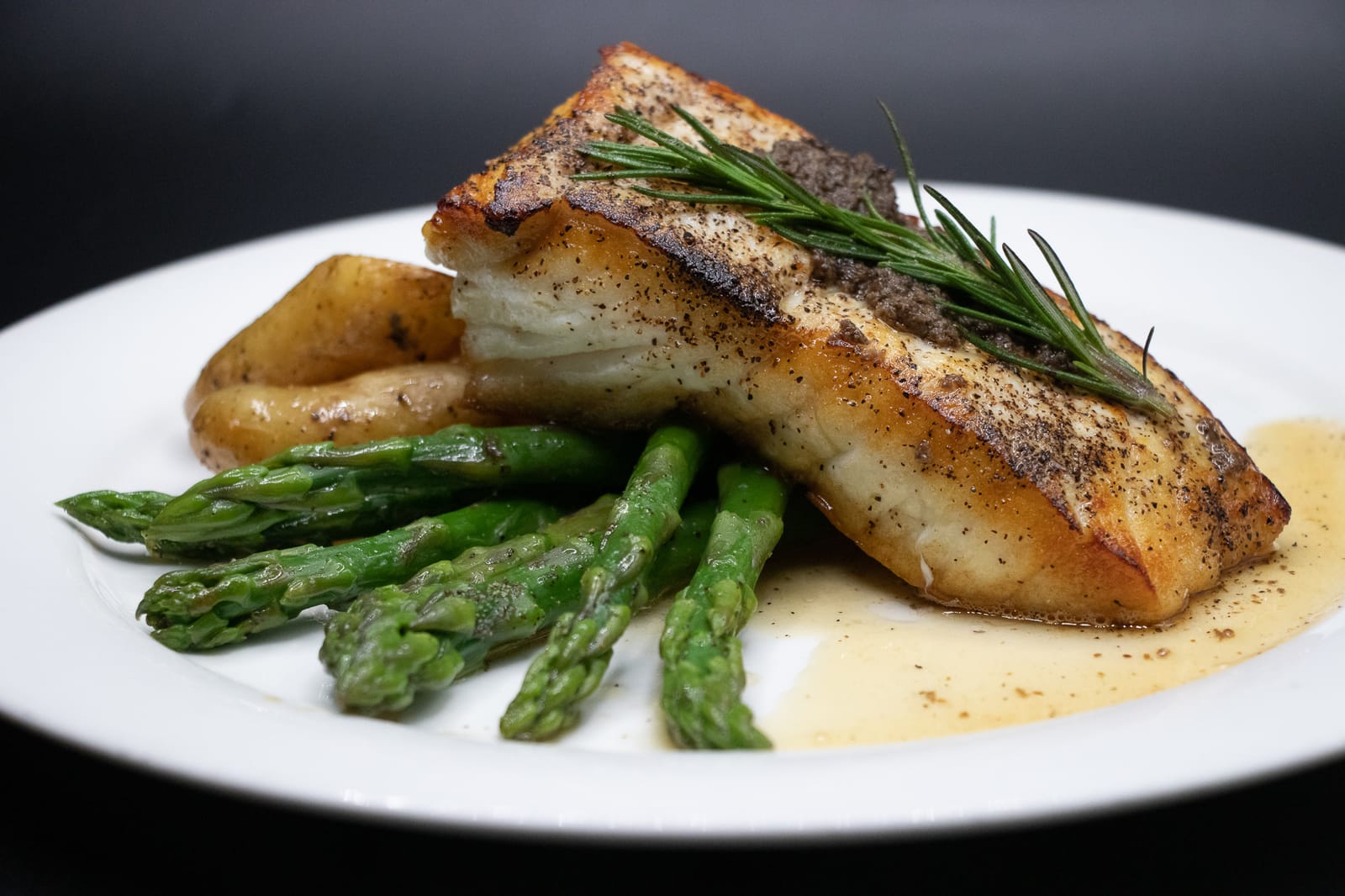 Pan-seared fish with grilled asparagus and roasted potatoes